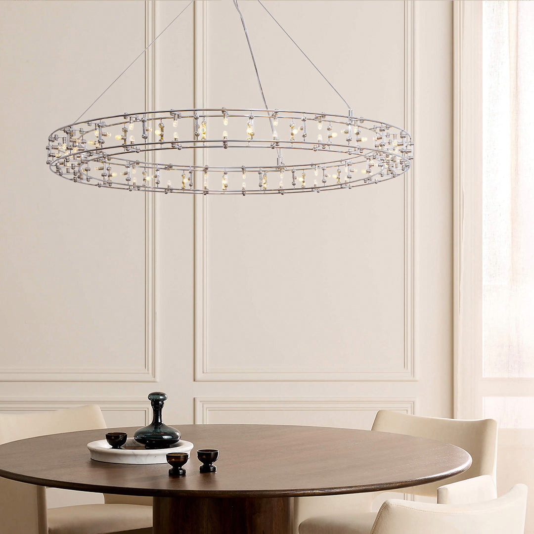 Modern chandelier hanging above a dining table in a stylish room.