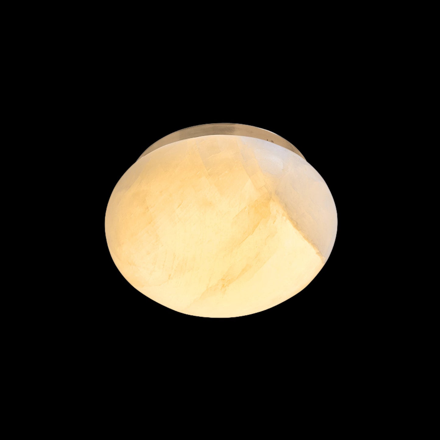 Round light fixture with a warm glow on a black background
