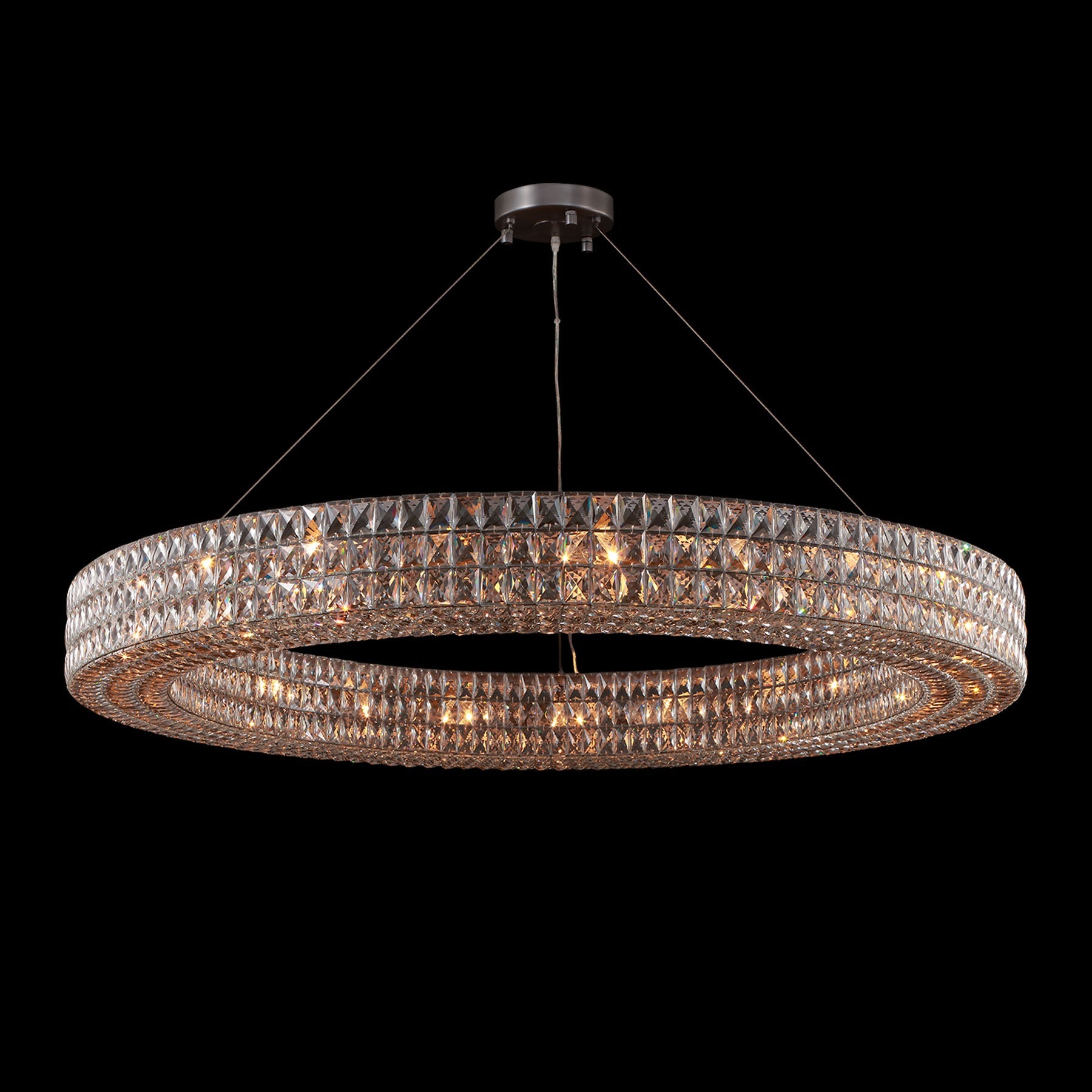 Chandelier with multiple rings of crystals on a black background