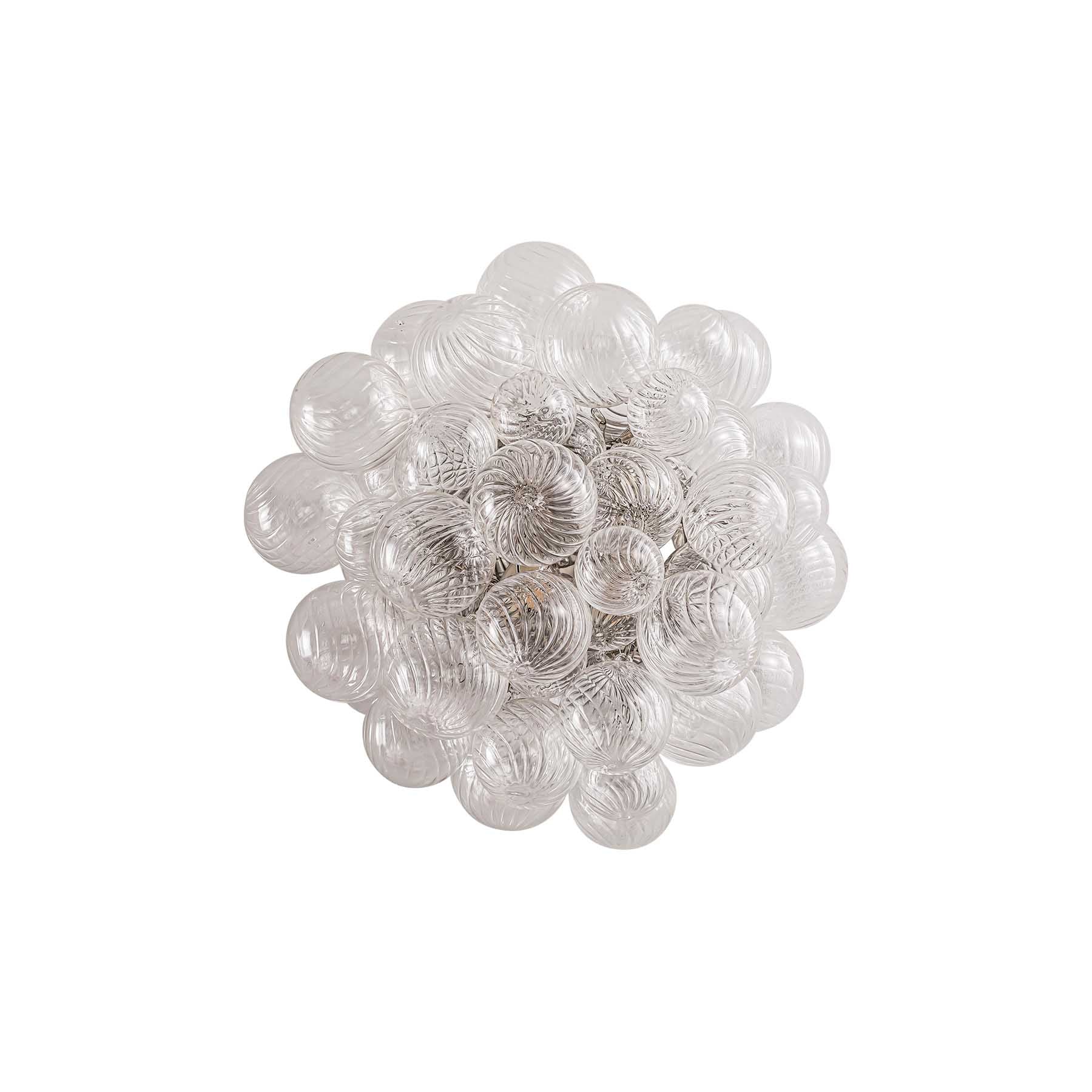 Decorative wall art with spherical glass elements on a white background